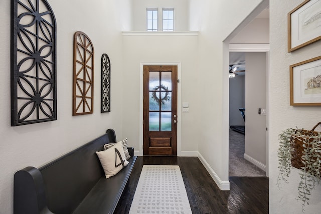 entrance foyer with baseboards, a ceiling fan, and dark wood finished floors