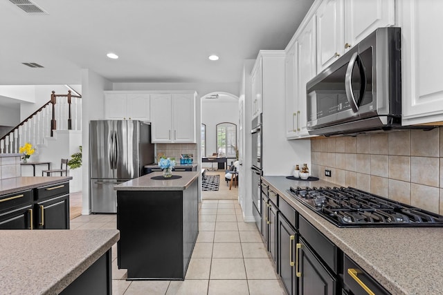 kitchen featuring stainless steel appliances, visible vents, and white cabinetry