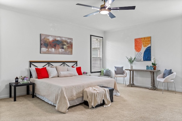 carpeted bedroom with crown molding, baseboards, and ceiling fan