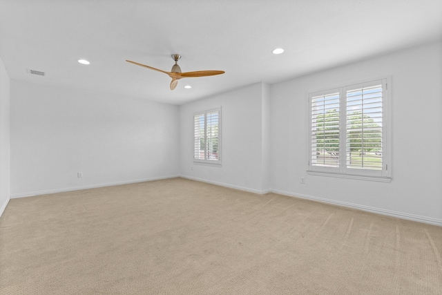 spare room featuring recessed lighting, a ceiling fan, visible vents, and light carpet