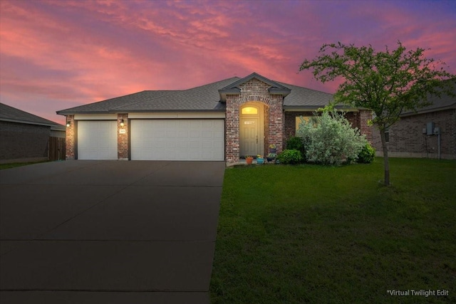 ranch-style house featuring roof with shingles, a lawn, brick siding, concrete driveway, and an attached garage