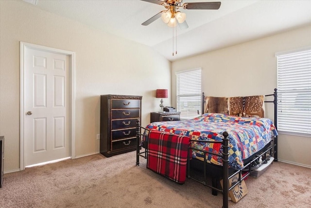 carpeted bedroom featuring baseboards, a ceiling fan, and vaulted ceiling