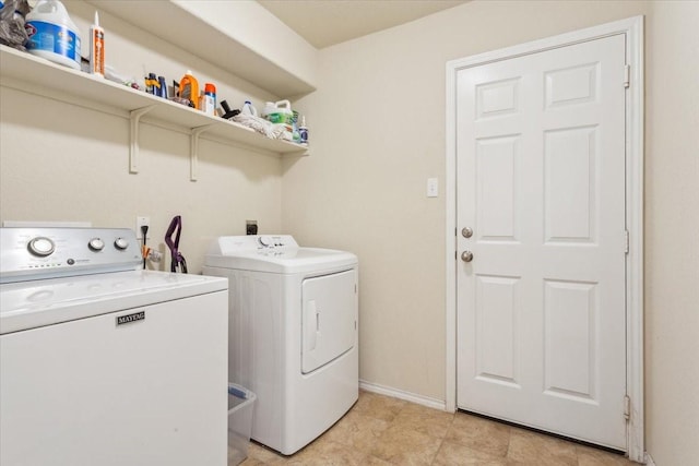 clothes washing area featuring baseboards, laundry area, and independent washer and dryer