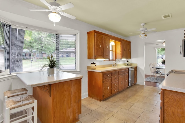 kitchen featuring light countertops, ceiling fan, a sink, and dishwasher