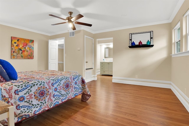 bedroom featuring a ceiling fan, visible vents, wood finished floors, baseboards, and ornamental molding