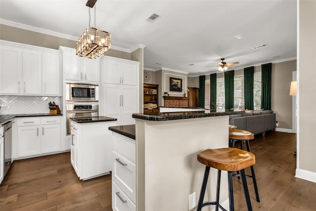 504 Glenbrook Ct, Southlake, TX 76092 - kitchen with visible vents, open floor plan, a center island, appliances with stainless steel finishes, and backsplash