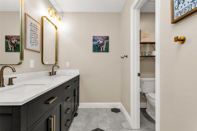 504 Glenbrook Ct, Southlake, TX 76092 - bathroom featuring baseboards, double vanity, tile patterned floors, and a sink