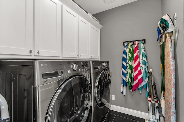 504 Glenbrook Ct, Southlake, TX 76092 - laundry room featuring washing machine and clothes dryer, dark tile patterned floors, baseboards, and cabinet space