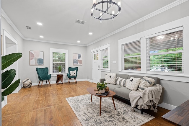 living area with a notable chandelier, visible vents, and ornamental molding
