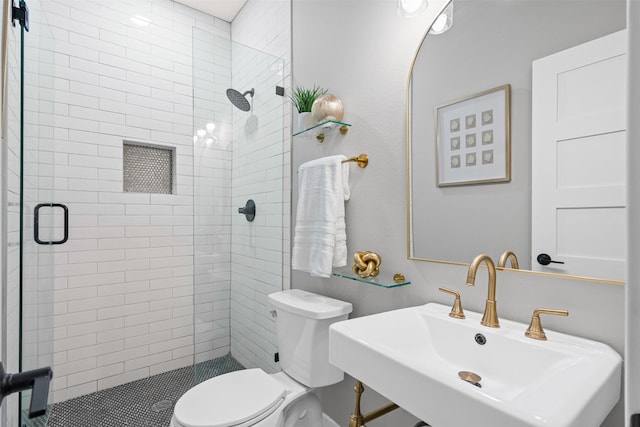 full bathroom with toilet, a sink, and a stall shower