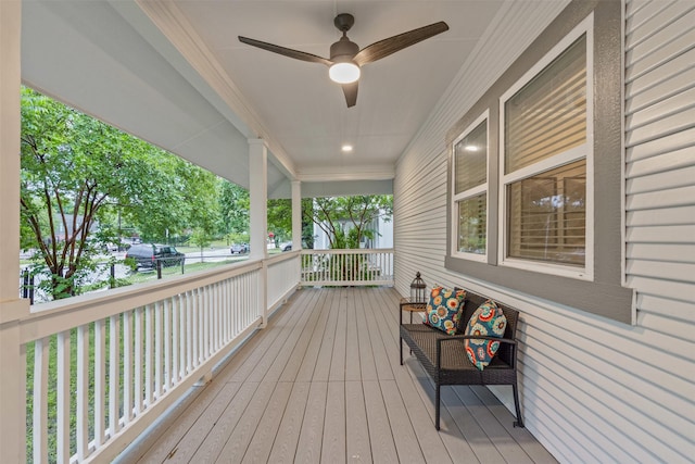 wooden terrace with a porch and ceiling fan
