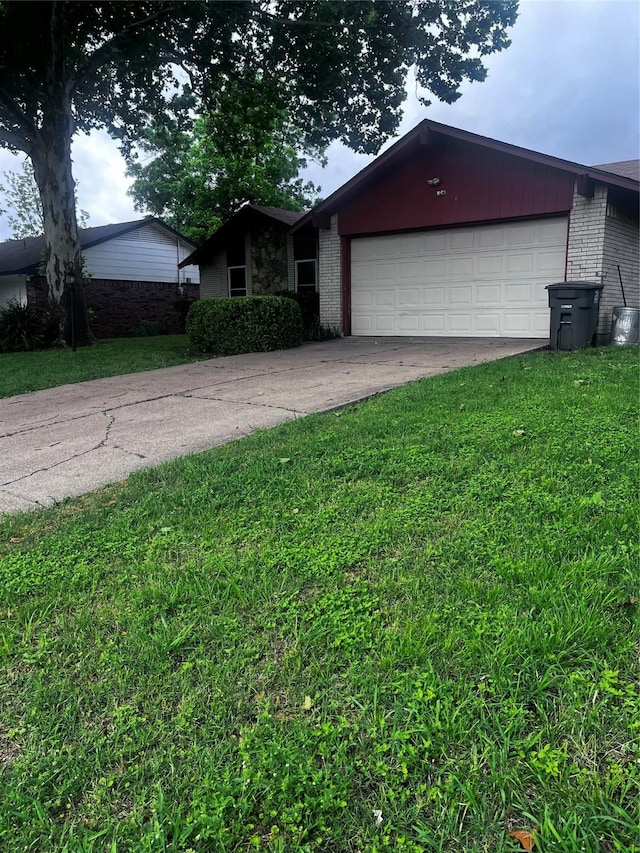2551 Mossglen Dr, Dallas, TX 75227 - view of front facade with brick siding, a garage, and a front yard