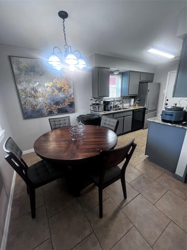 2551 Mossglen Dr, Dallas, TX 75227 - dining room featuring light tile patterned flooring, a chandelier, and baseboards