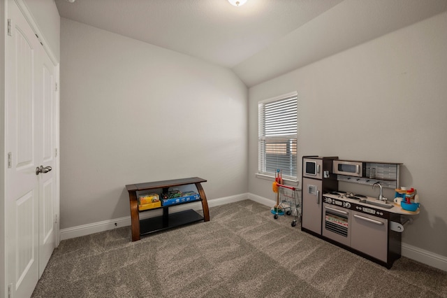 game room featuring baseboards, carpet, and vaulted ceiling