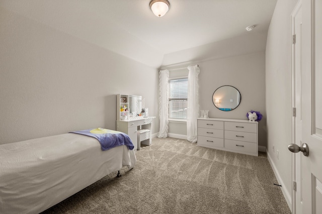 carpeted bedroom featuring baseboards and vaulted ceiling