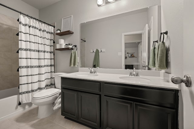 bathroom with double vanity, a sink, shower / tub combo, and toilet
