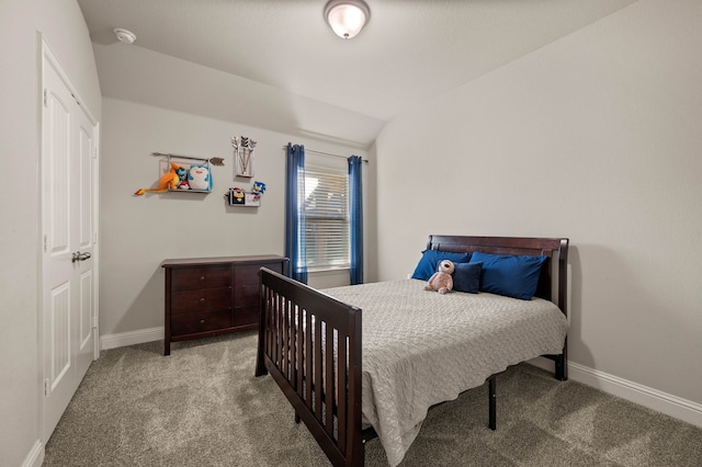 carpeted bedroom with baseboards and vaulted ceiling