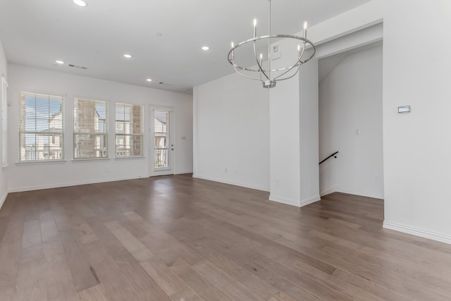 interior space with recessed lighting, an inviting chandelier, and wood finished floors