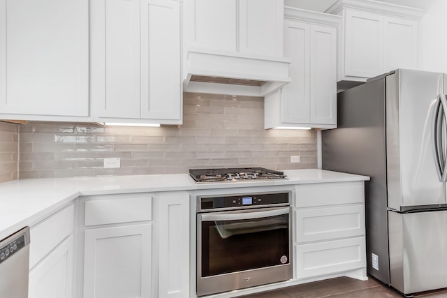 kitchen featuring white cabinets, appliances with stainless steel finishes, and light countertops