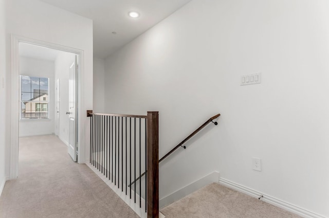 stairs with baseboards, recessed lighting, and carpet