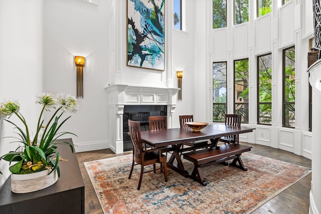dining area with a high ceiling and a fireplace