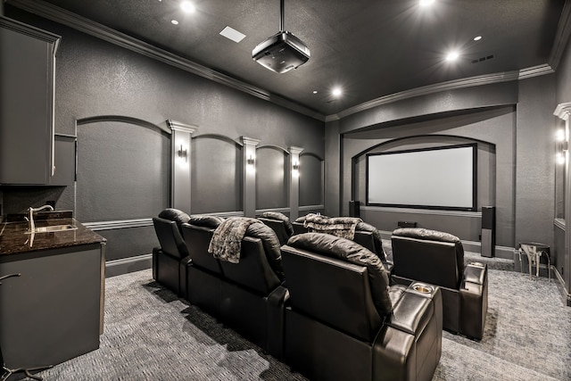 carpeted cinema room featuring a sink, a textured wall, ornamental molding, and recessed lighting