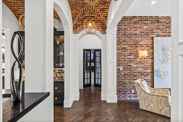 interior space featuring brick ceiling, brick wall, and vaulted ceiling
