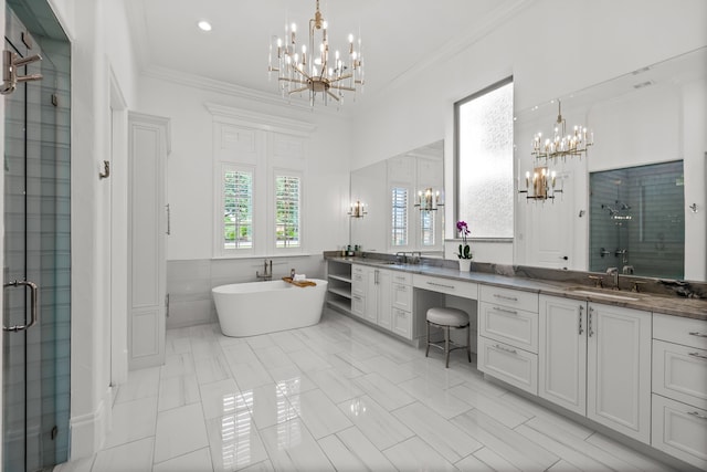 bathroom featuring an inviting chandelier, double vanity, a shower stall, and a sink