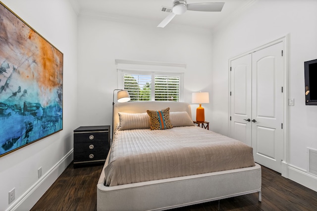 bedroom featuring a closet, ornamental molding, baseboards, and wood finished floors