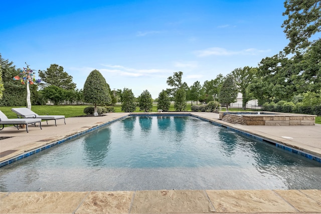 outdoor pool featuring a patio and an in ground hot tub