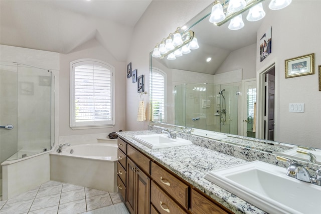 bathroom with a sink, a shower stall, vaulted ceiling, and a garden tub
