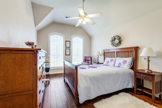 bedroom with baseboards, a ceiling fan, lofted ceiling, and dark wood-style floors