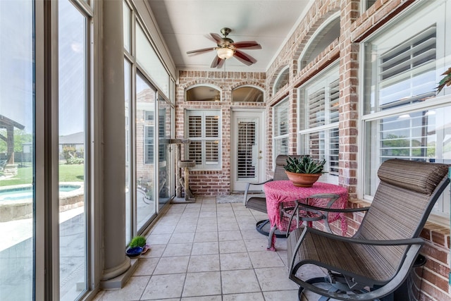 sunroom / solarium featuring ceiling fan