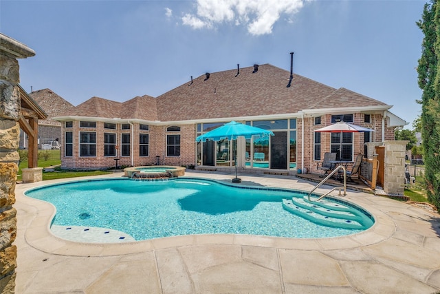 view of pool with a pool with connected hot tub and a patio area
