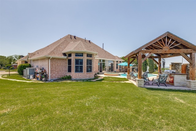 rear view of house with a gazebo, a yard, and a fenced in pool