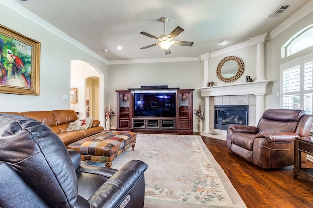 living room with arched walkways, ceiling fan, ornamental molding, and hardwood / wood-style flooring