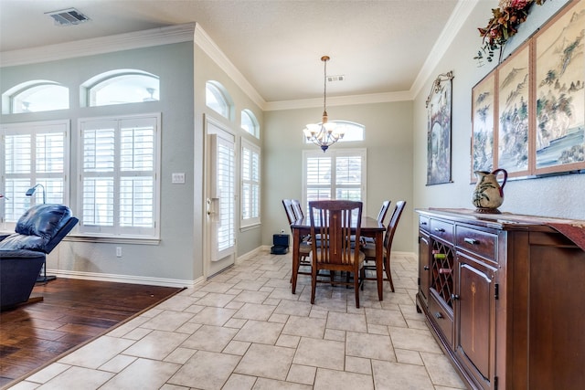 dining room featuring visible vents, ornamental molding, baseboards, and an inviting chandelier
