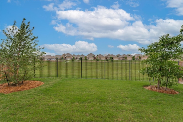 view of yard featuring fence and a residential view