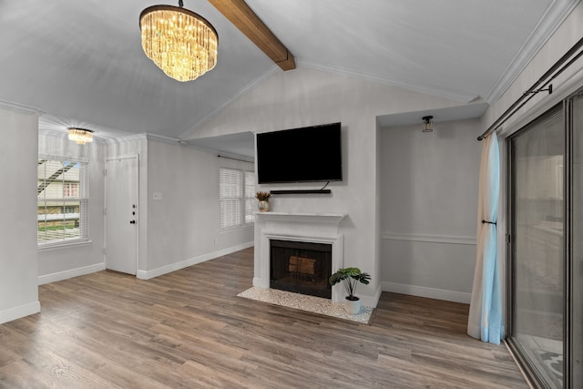 unfurnished living room featuring a fireplace with flush hearth, baseboards, lofted ceiling with beams, and a chandelier