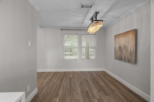 unfurnished dining area featuring visible vents, ornamental molding, dark wood finished floors, and baseboards