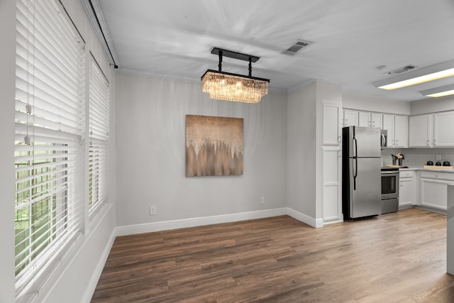 kitchen with visible vents, appliances with stainless steel finishes, wood finished floors, and a wealth of natural light
