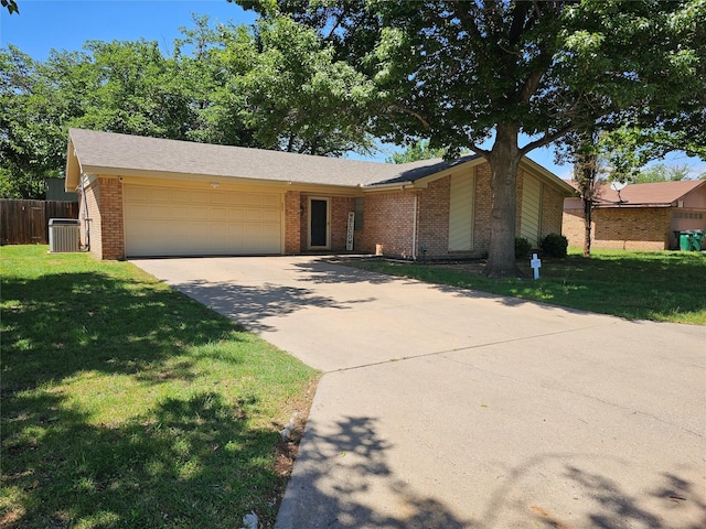 view of front of home featuring brick siding, an attached garage, driveway, and a front lawn