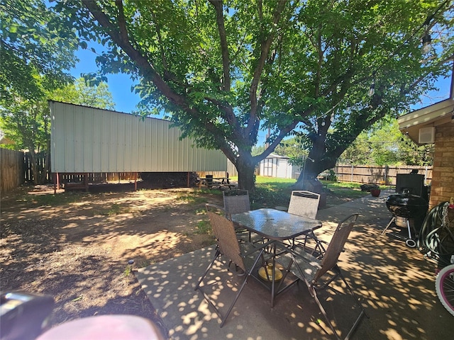 view of patio with outdoor dining area and a fenced backyard