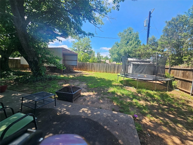 view of yard with a fenced backyard and a trampoline