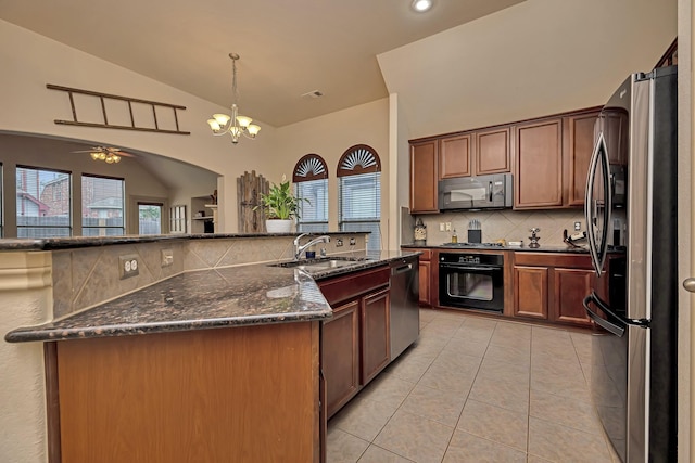 kitchen with lofted ceiling, tasteful backsplash, a sink, light tile patterned floors, and black appliances