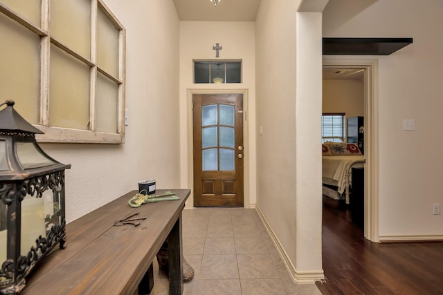 tiled entryway featuring baseboards