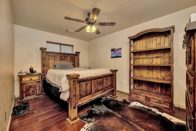 bedroom with dark wood-style flooring, a ceiling fan, and visible vents