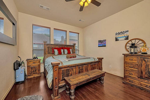 bedroom featuring baseboards, visible vents, and wood finished floors