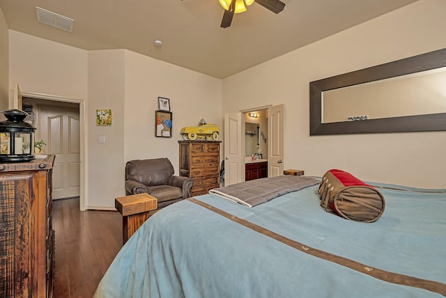 bedroom featuring a ceiling fan, visible vents, baseboards, connected bathroom, and dark wood-type flooring