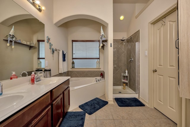 full bathroom featuring tile patterned flooring, a sink, a bath, and a shower stall